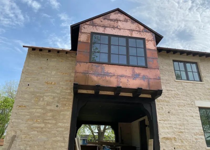 Copper metal panel facade on a stone building for Roof Repair in Aransas Pass