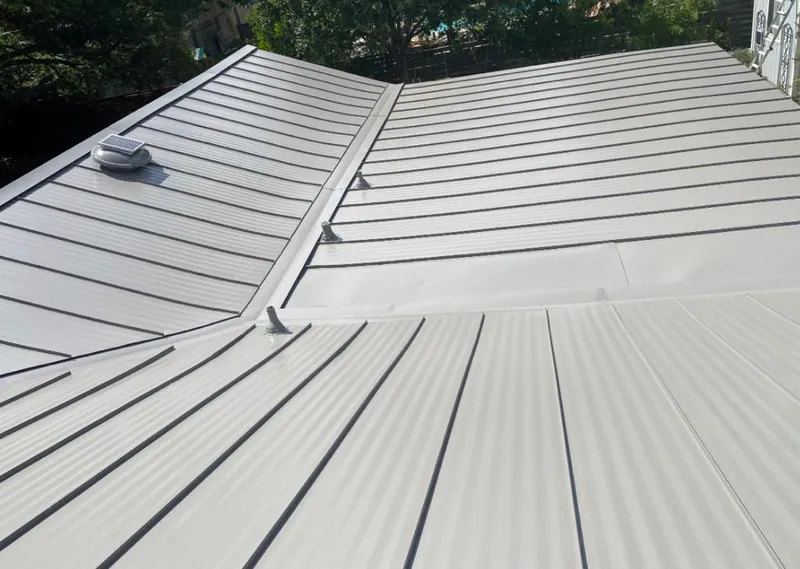 Solar attic fan installed on a metal roof for Roof Ventilation in Aransas Pass