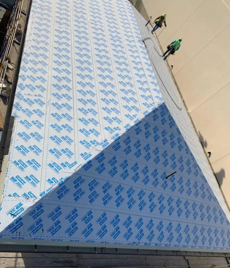 Professional roofers installing underlayment on a metal roof in Aransas Pass